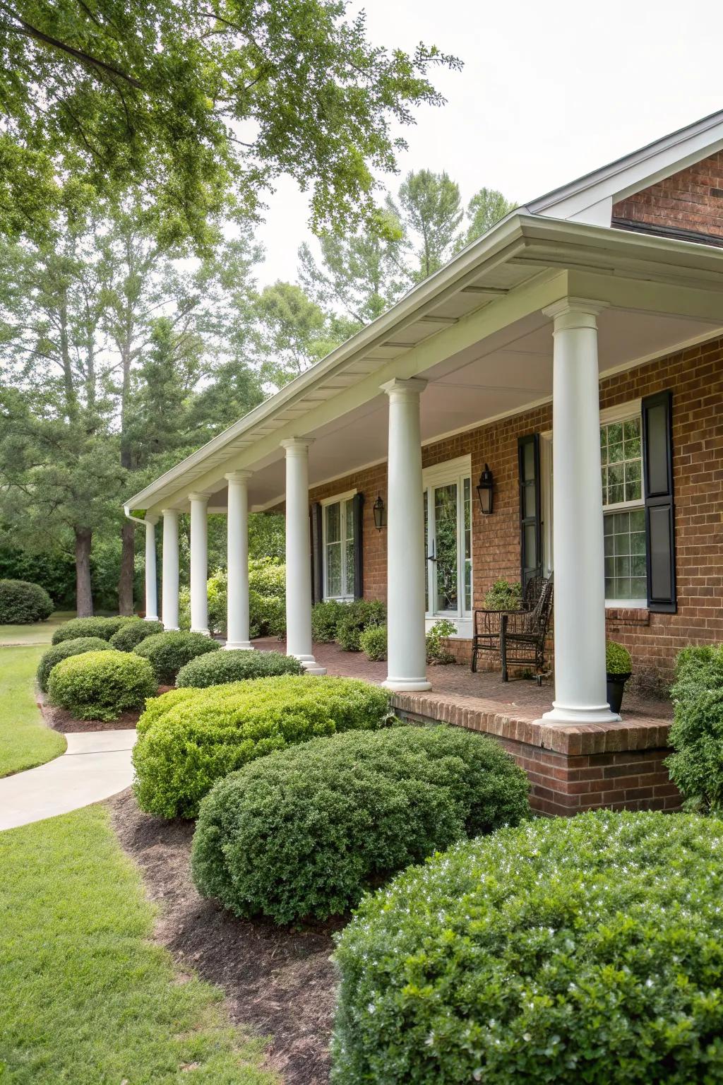 White columns add a touch of elegance to the brick ranch front porch.