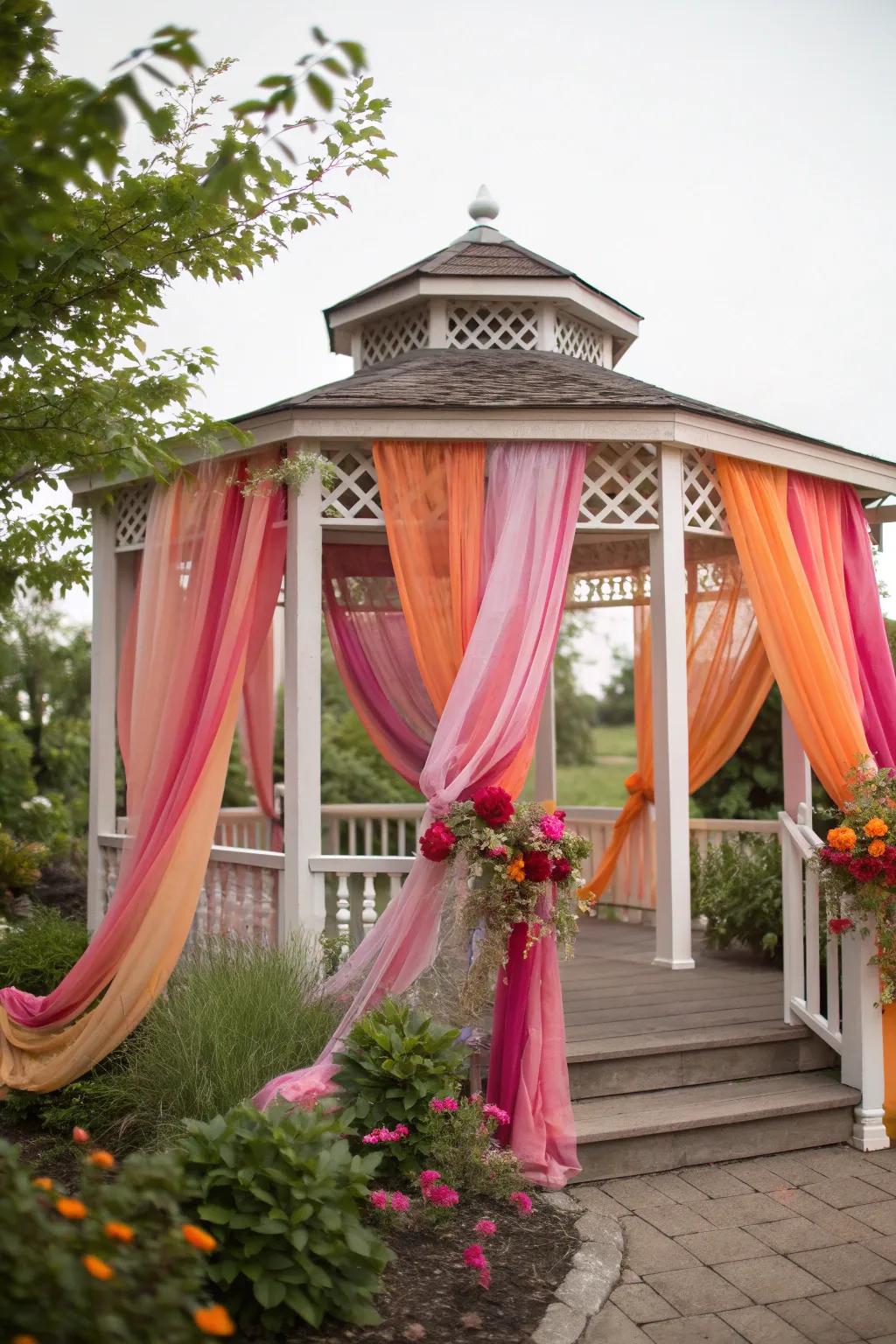 A gazebo transformed with colorful drapes for a lively party atmosphere.
