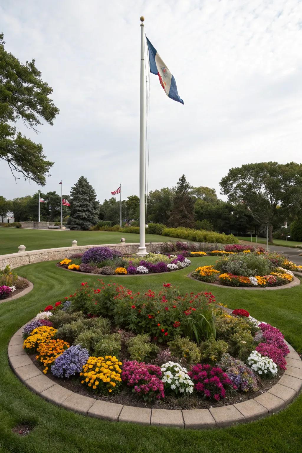 Circular flower beds create a colorful embrace around the flagpole.