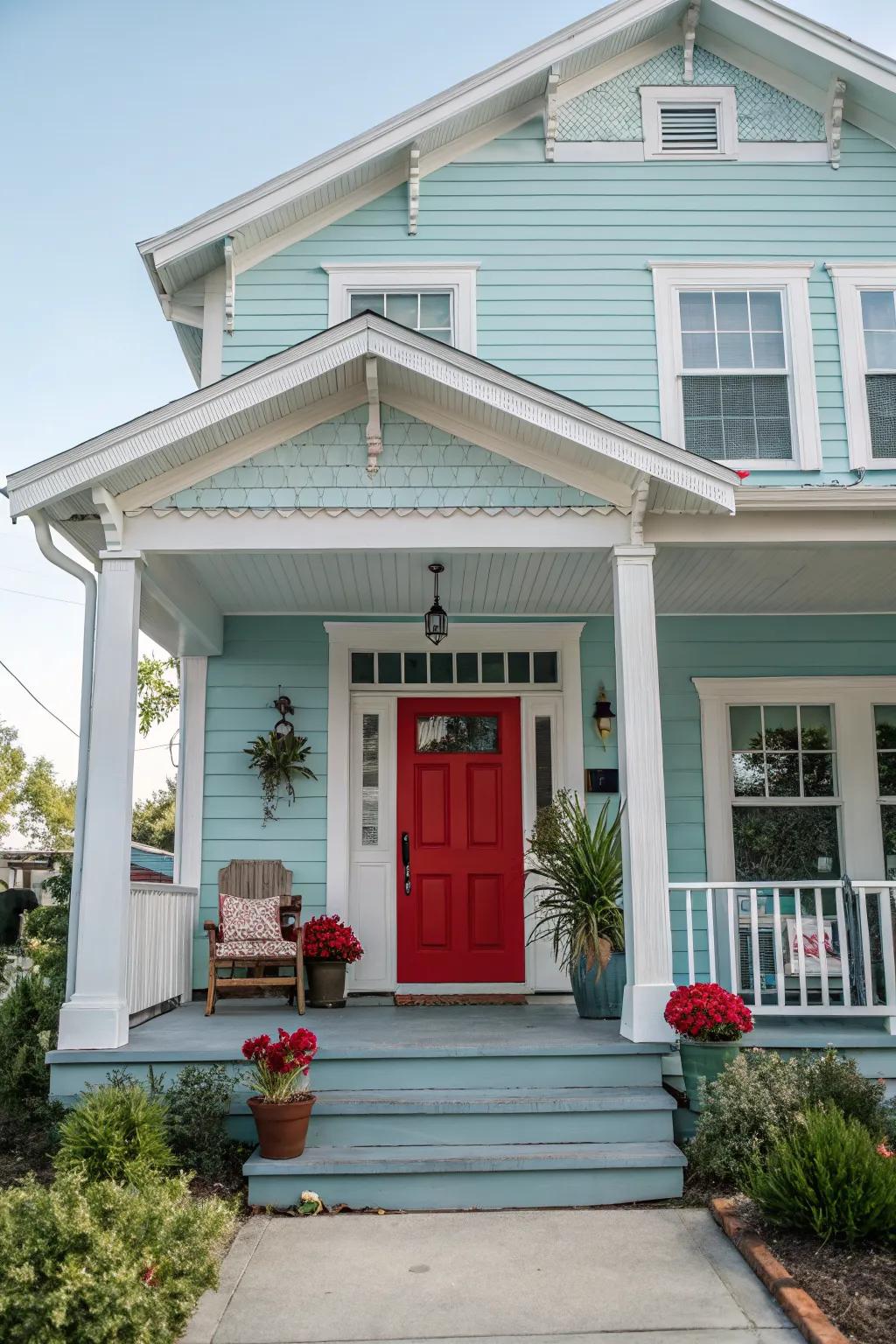 A classic red door brings a bold contrast to a light blue home.