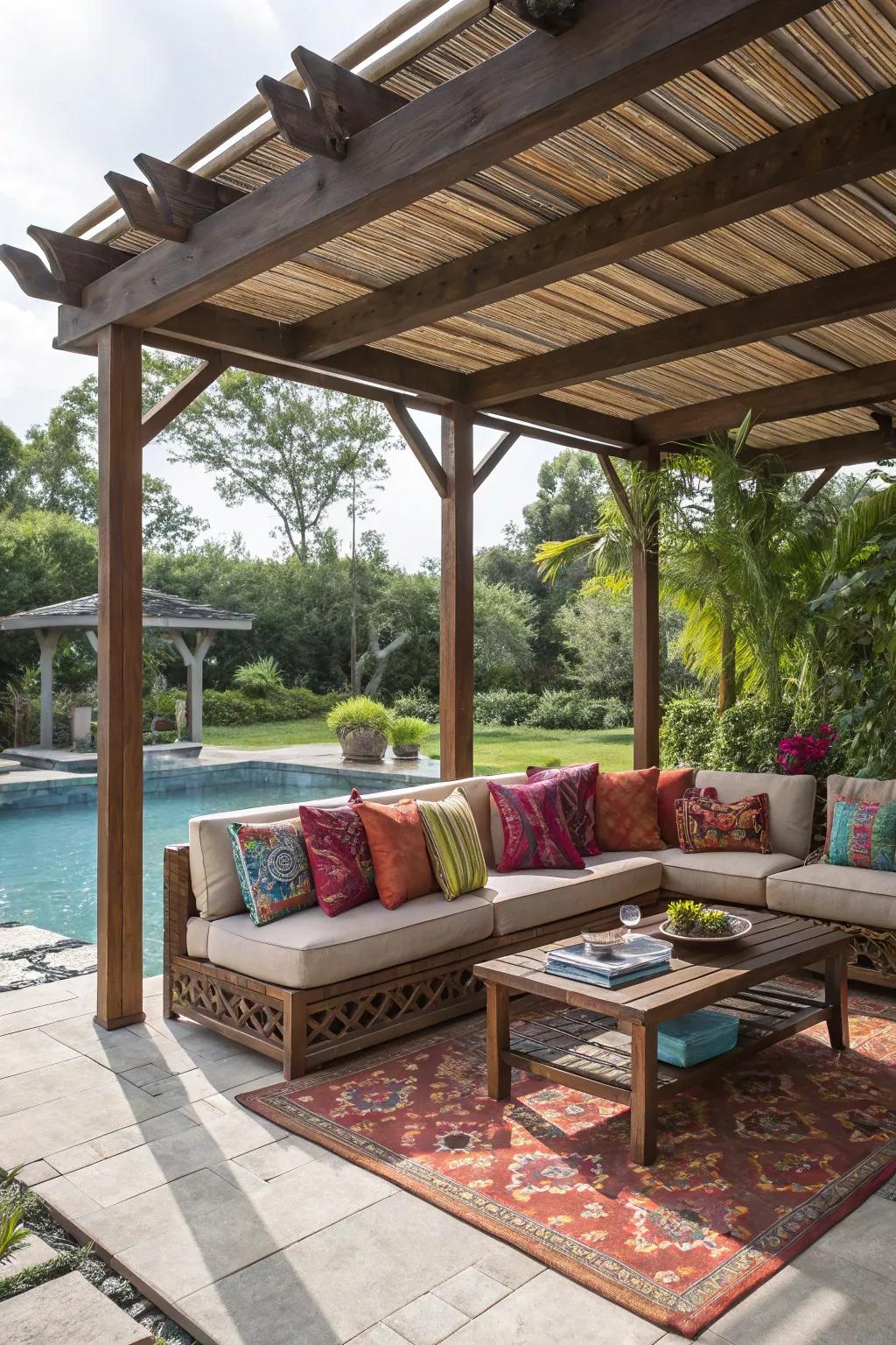 A cozy poolside pergola with inviting seating and colorful cushions.
