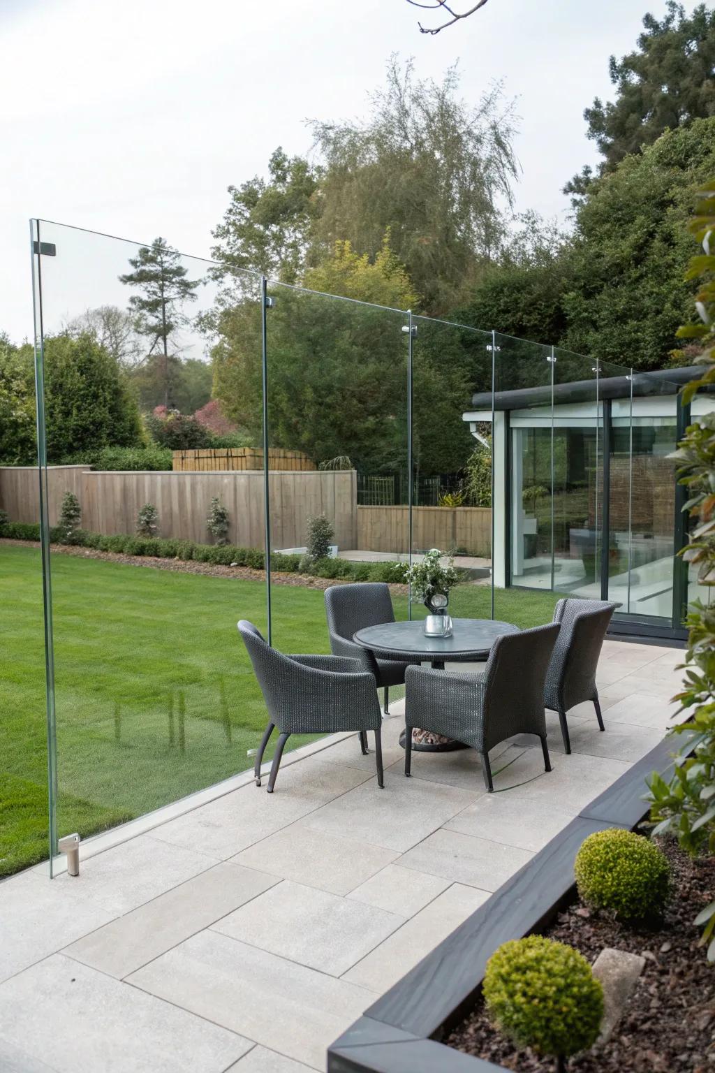 Clear glass panels offering a seamless view of a stylish patio.