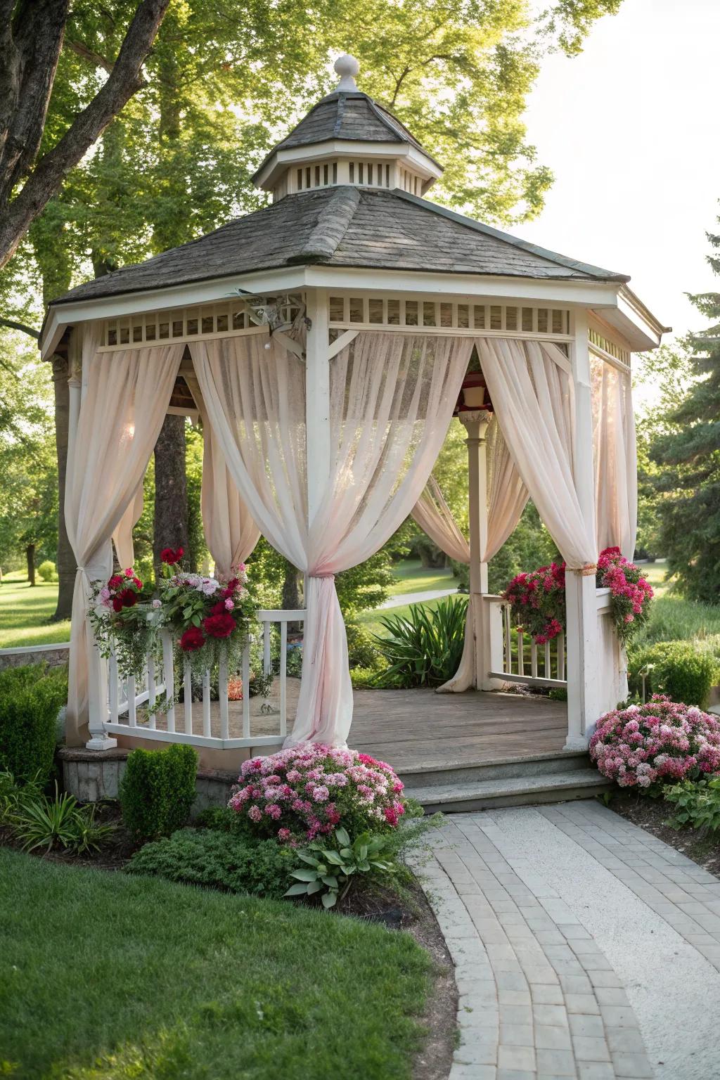 A gazebo exuding romance with flowing drapes.