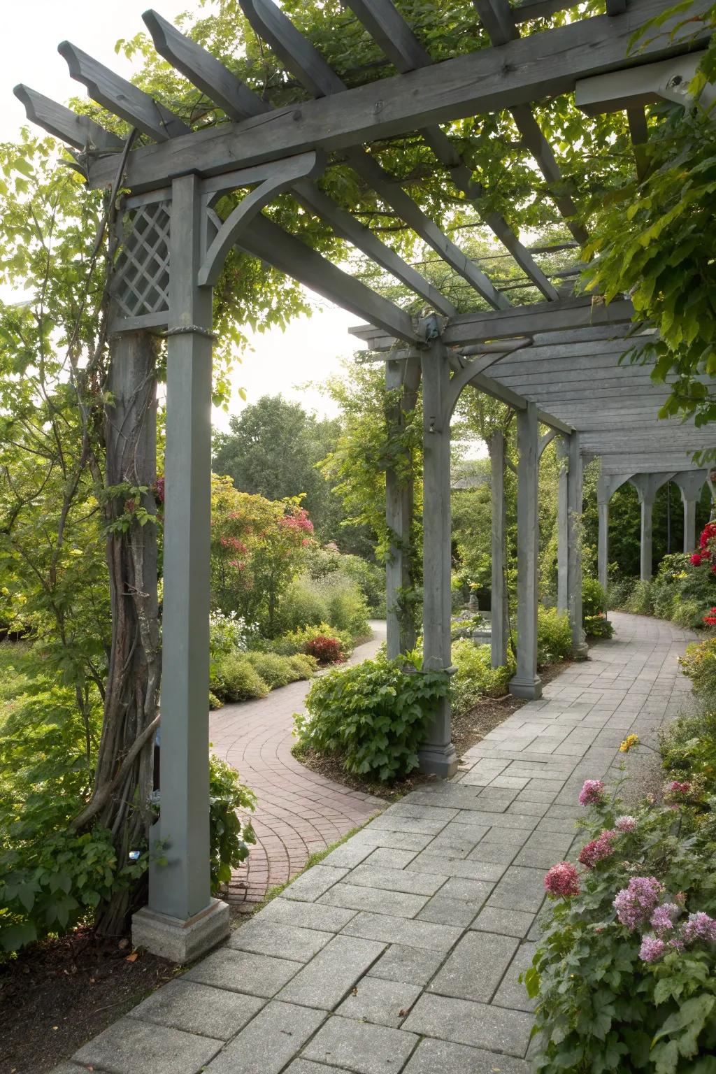 A grey pergola offering stylish shade in a sunlit garden.