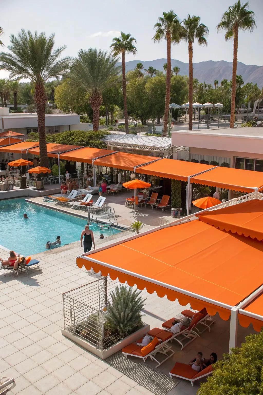 Orange awnings create an energetic and inviting poolside atmosphere.