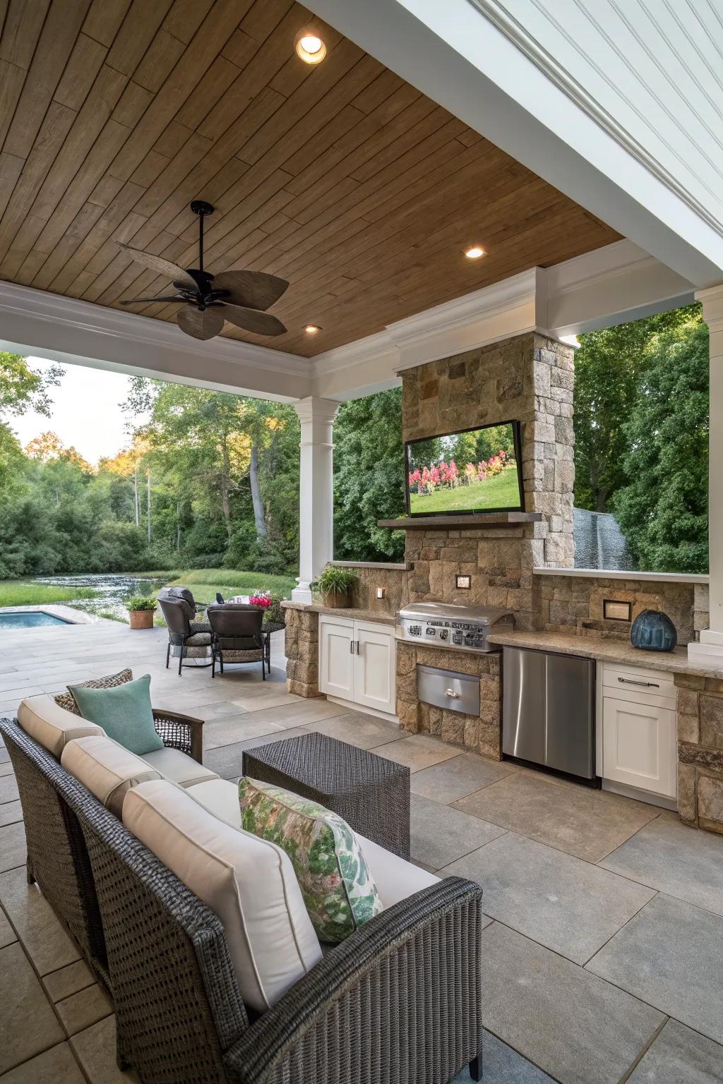 An entertainment area with an outdoor TV makes this back patio kitchen a hub for fun.