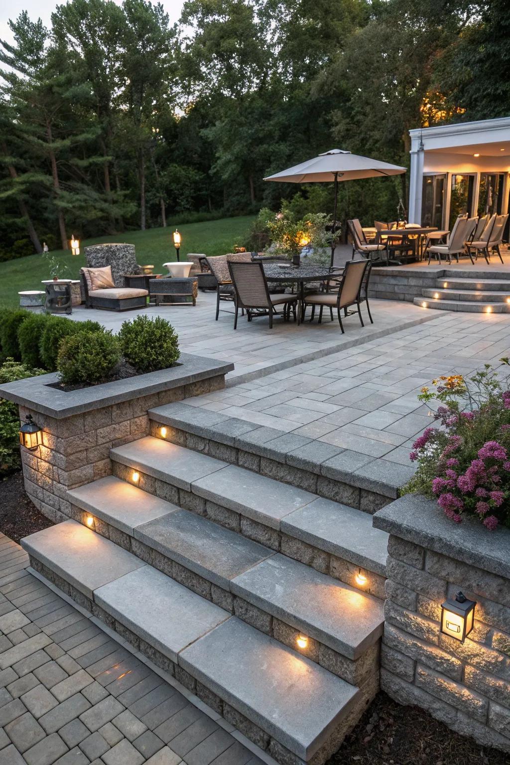 A multi-level design adds dimension and defines zones on a gray paver patio.