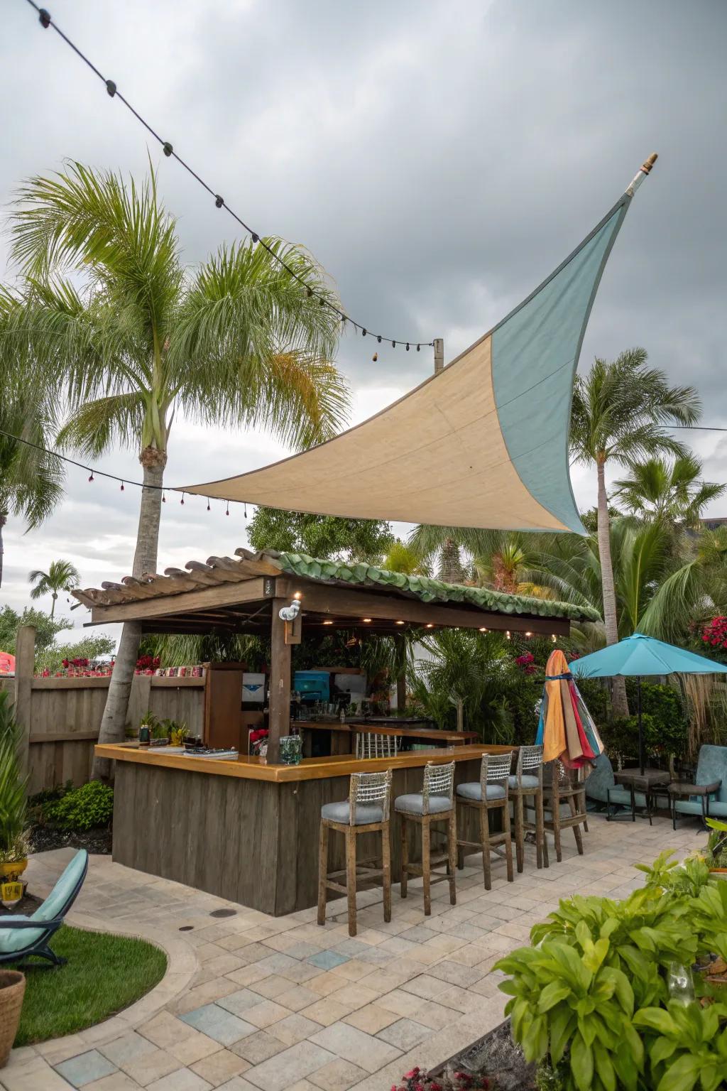 A sail shade brings a casual, beachy feel to your outdoor bar.