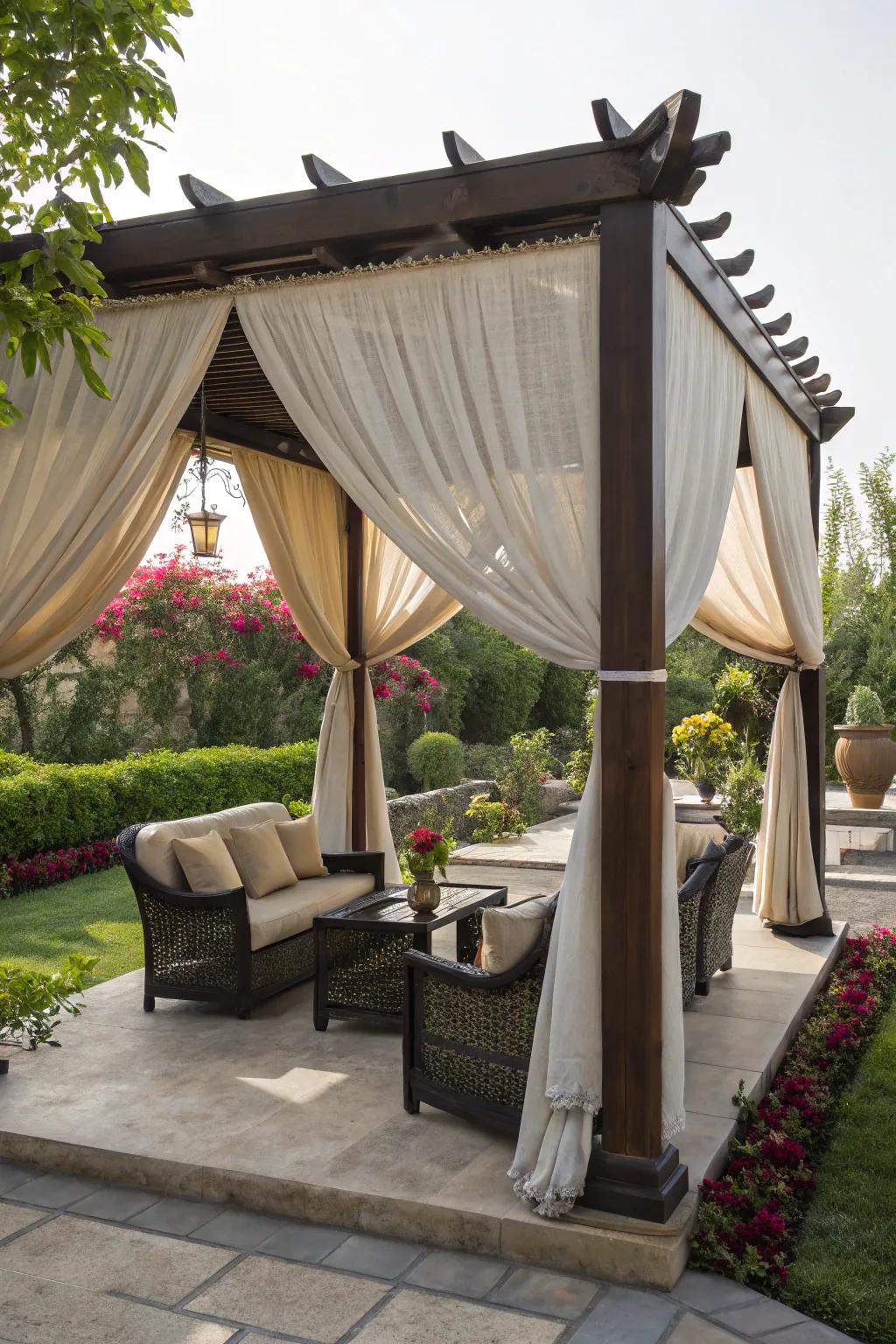 Fabric draping transforms your pergola into a cozy tent retreat.