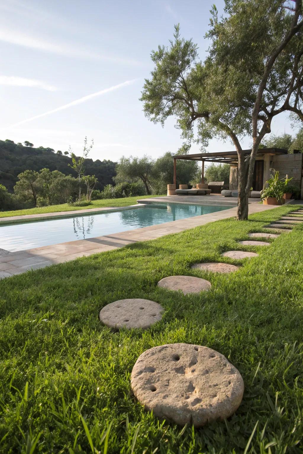 Accent stones adding sophistication to a grassy pool border.