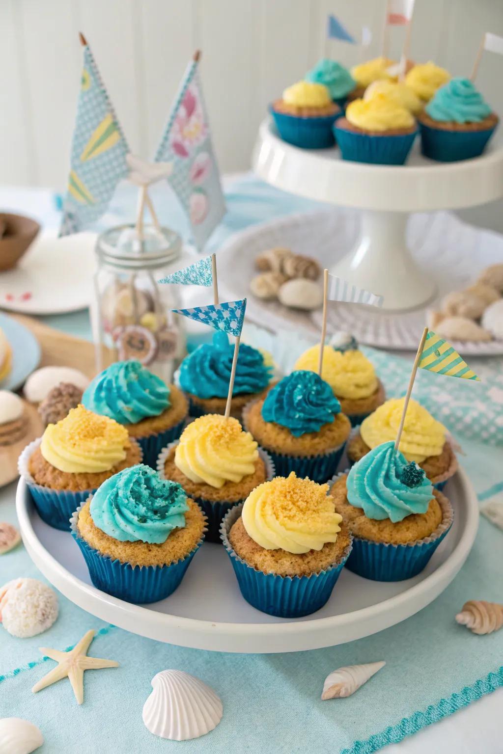 Dessert table with beach-themed cupcakes decorated with crushed cookie 'sand' and ocean accents.