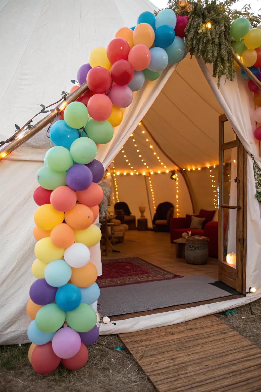 A colorful balloon arch adds a festive touch to this tent entrance.