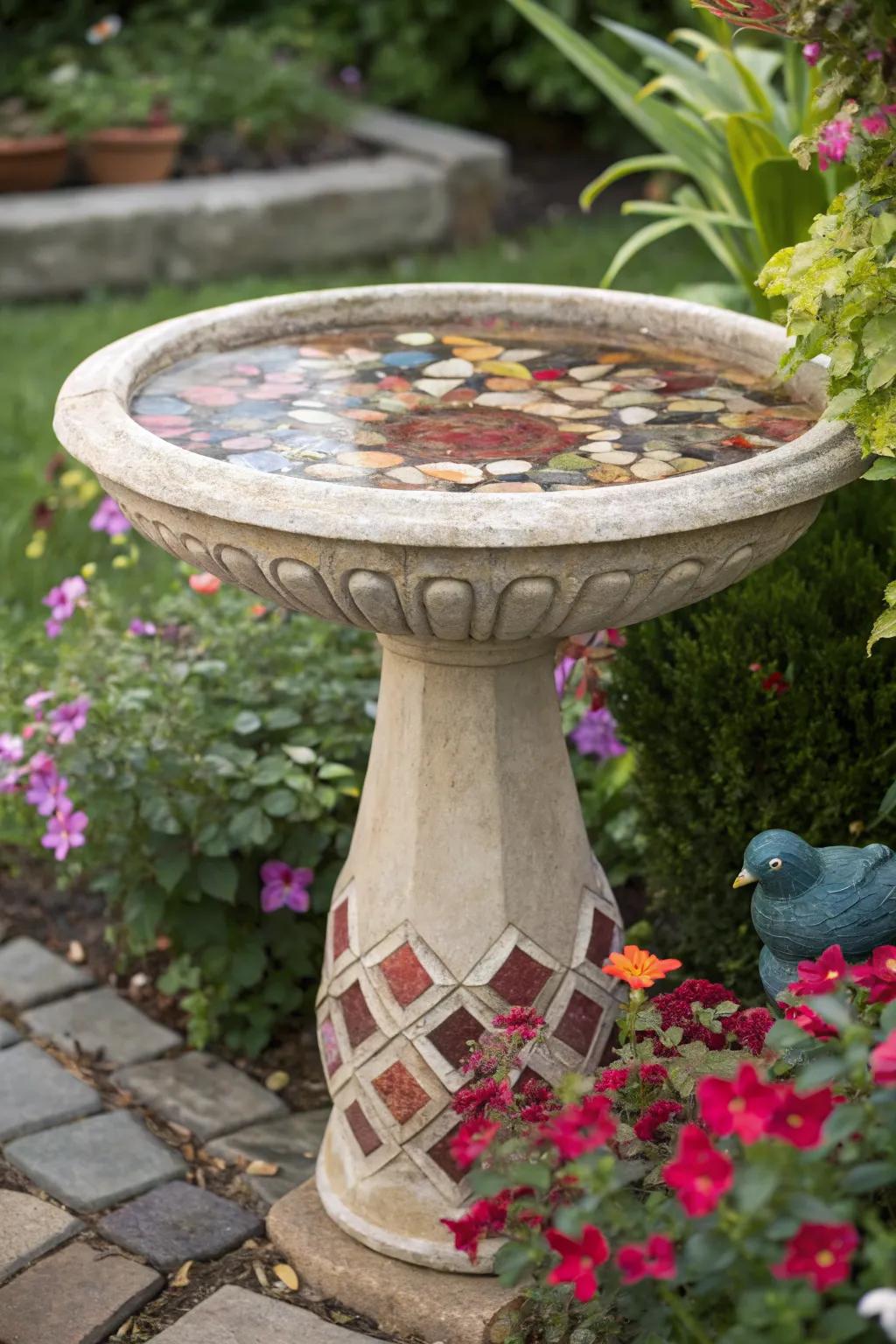 A decorative stone mosaic birdbath offers both beauty and function.