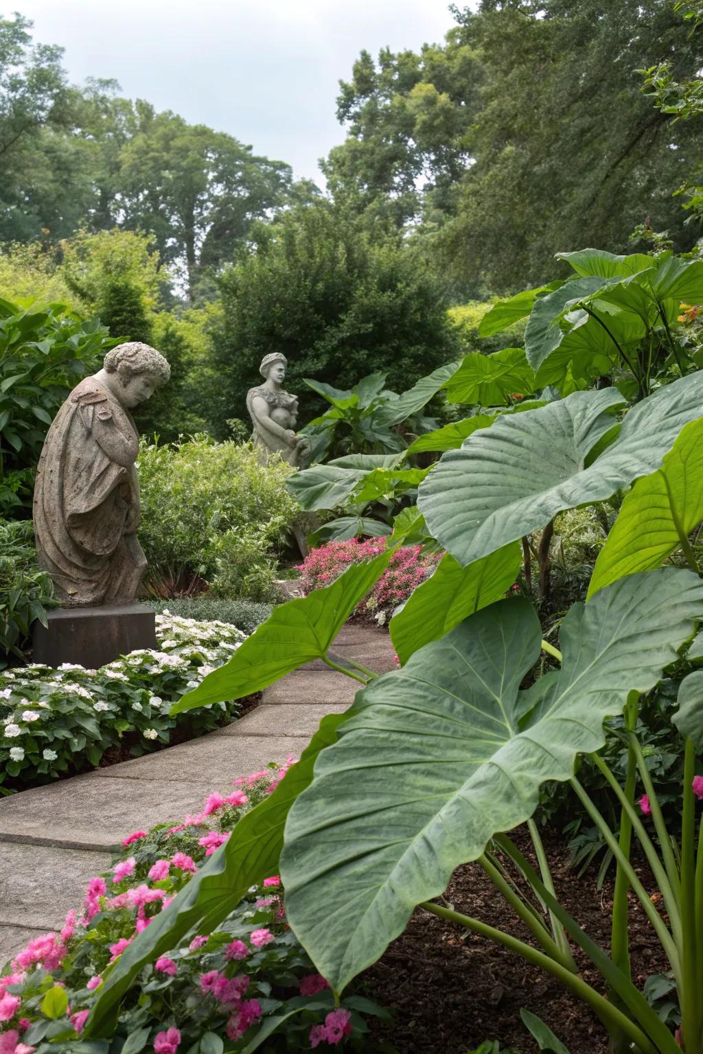 Blend art and nature with sculptures among lush elephant ears.