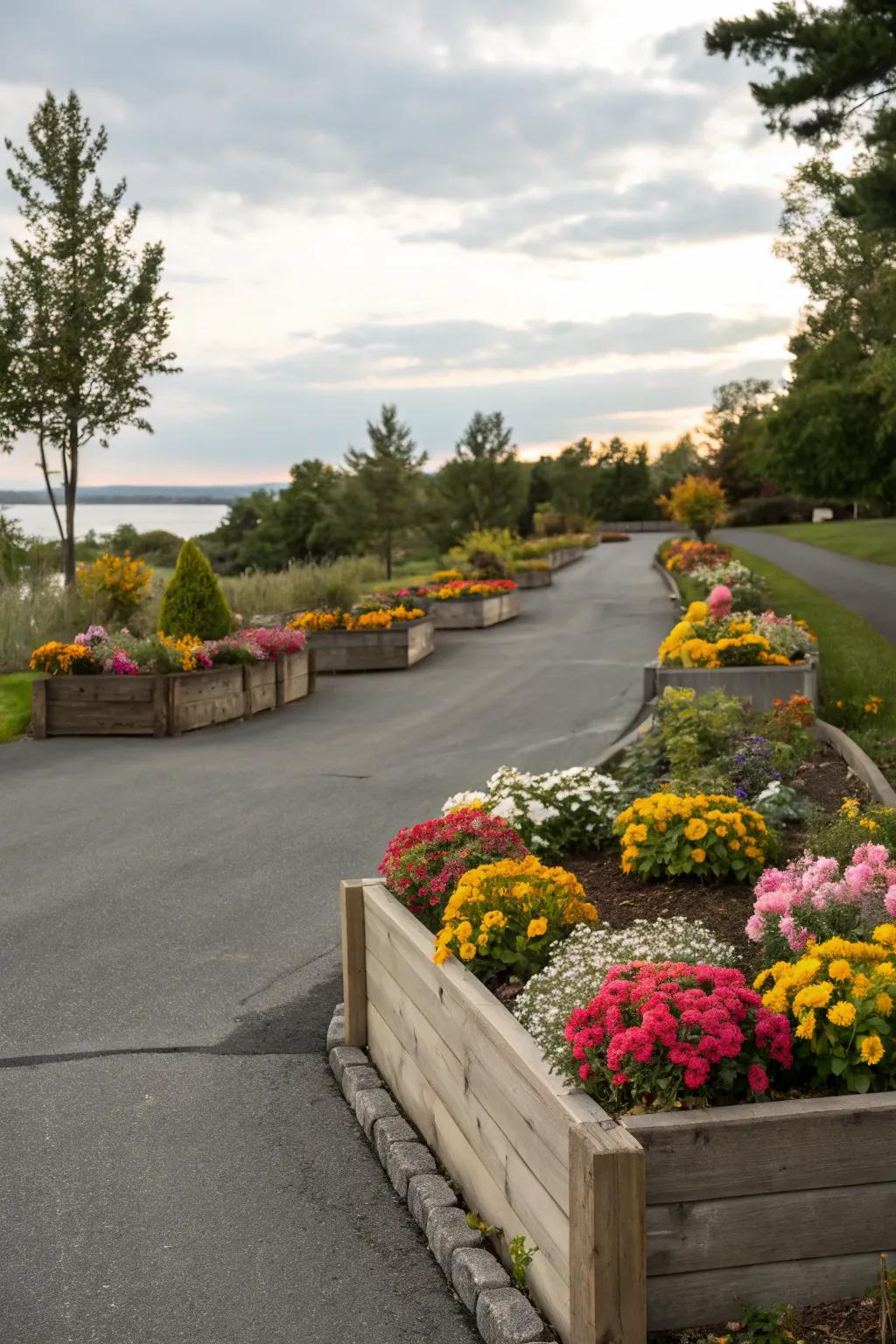 Driveway enhanced by colorful raised plant beds.