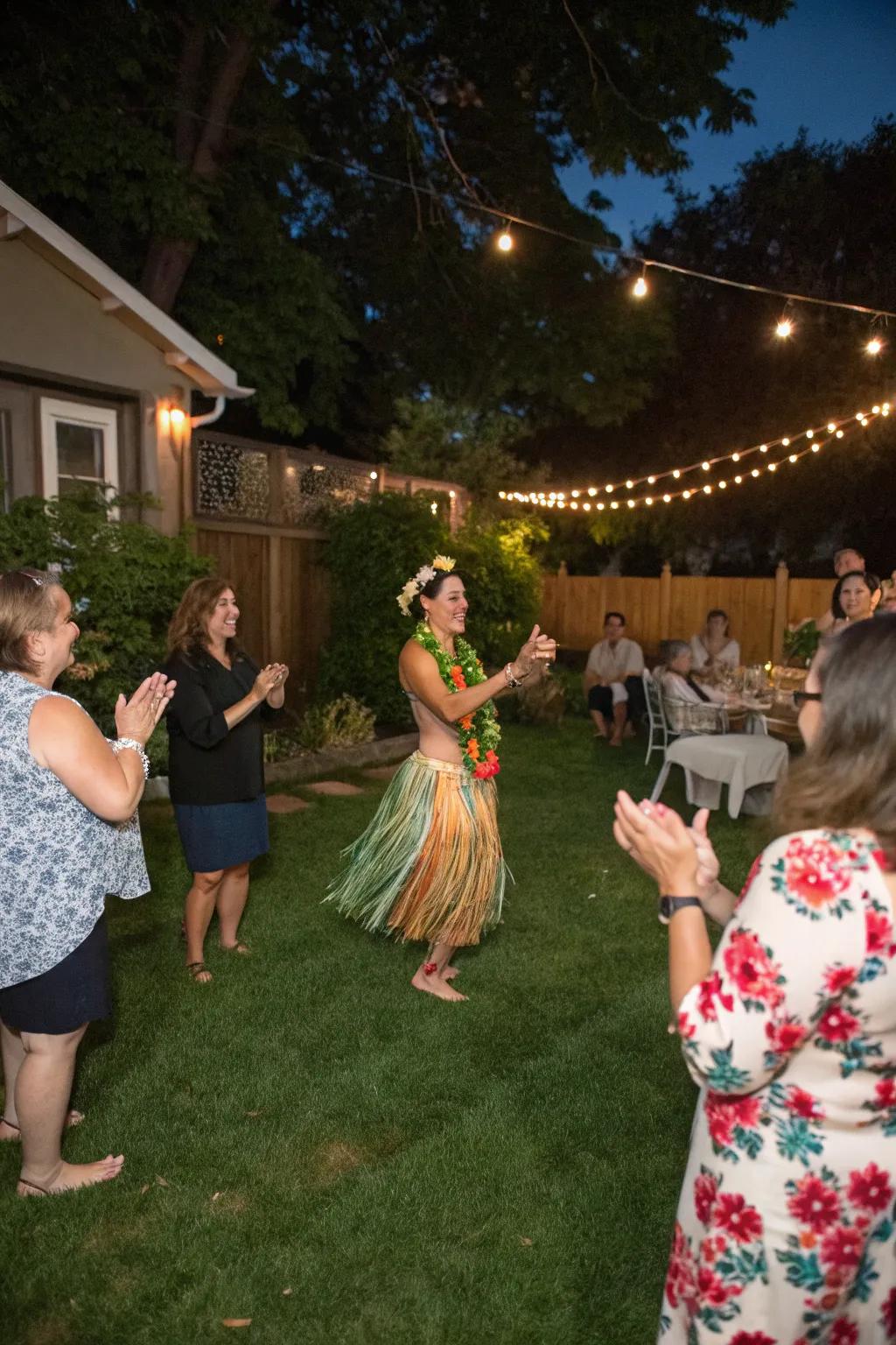 Backyard party with a hula dancer performing and guests clapping along.