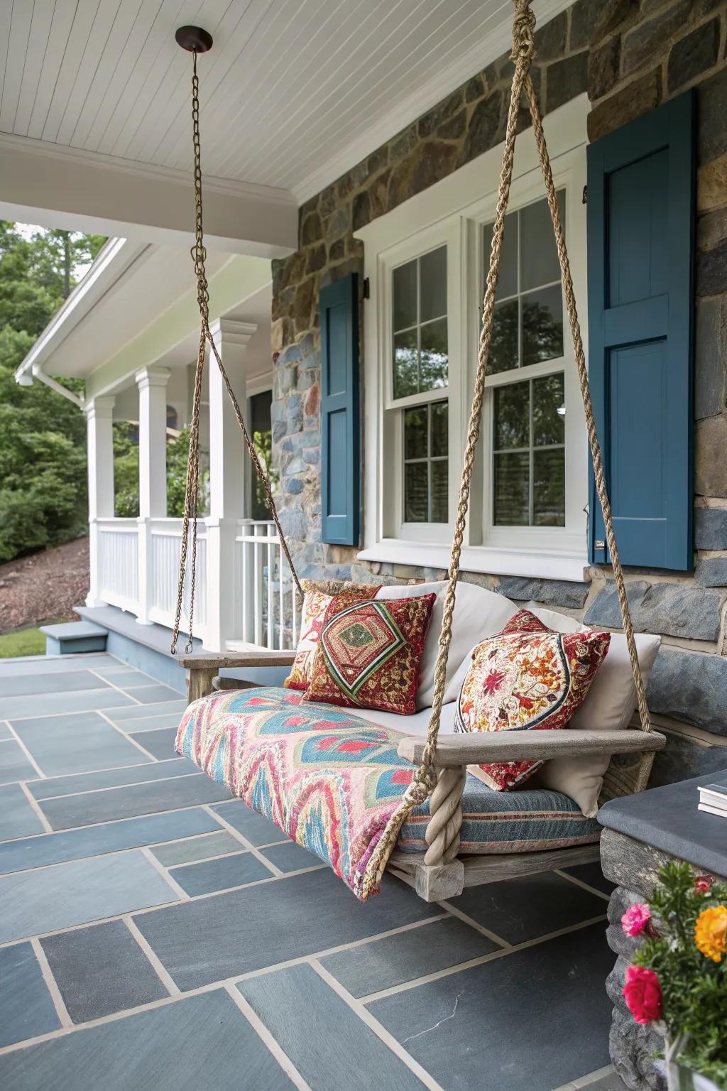 A bluestone porch with a charming swing chair.