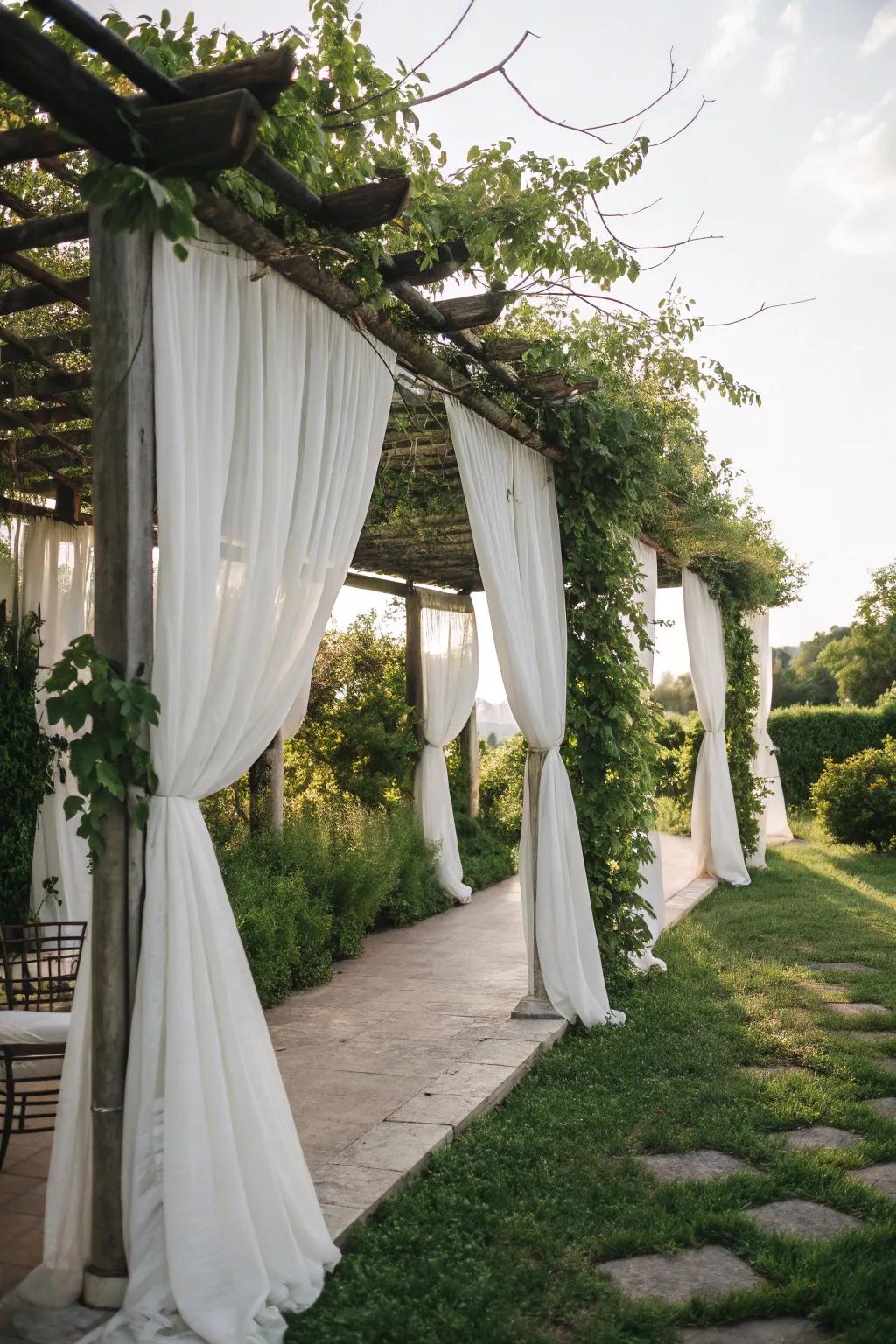A pergola with drapes providing a semi-private garden retreat.
