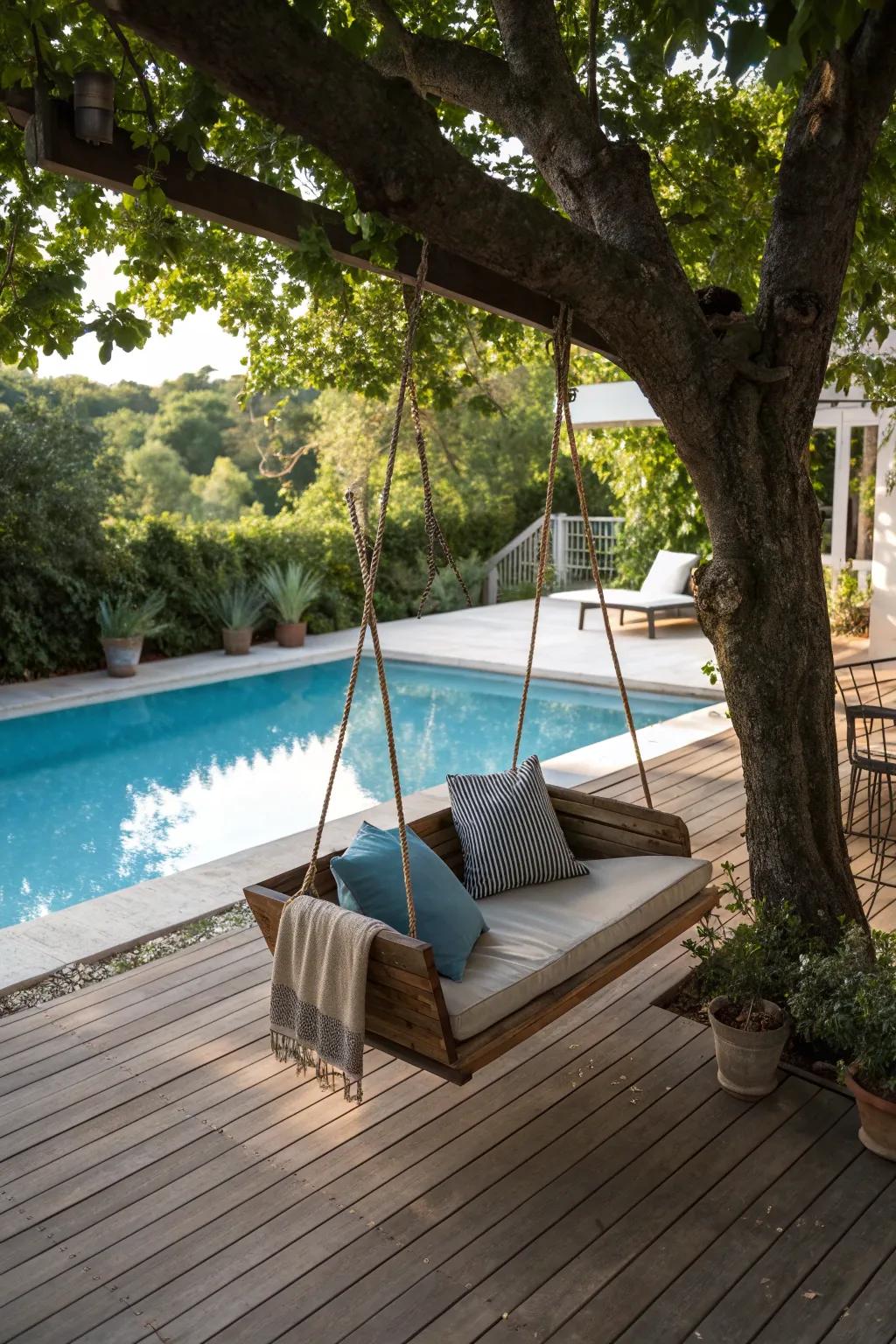 A cozy deck swing on a pool deck shaded by trees.