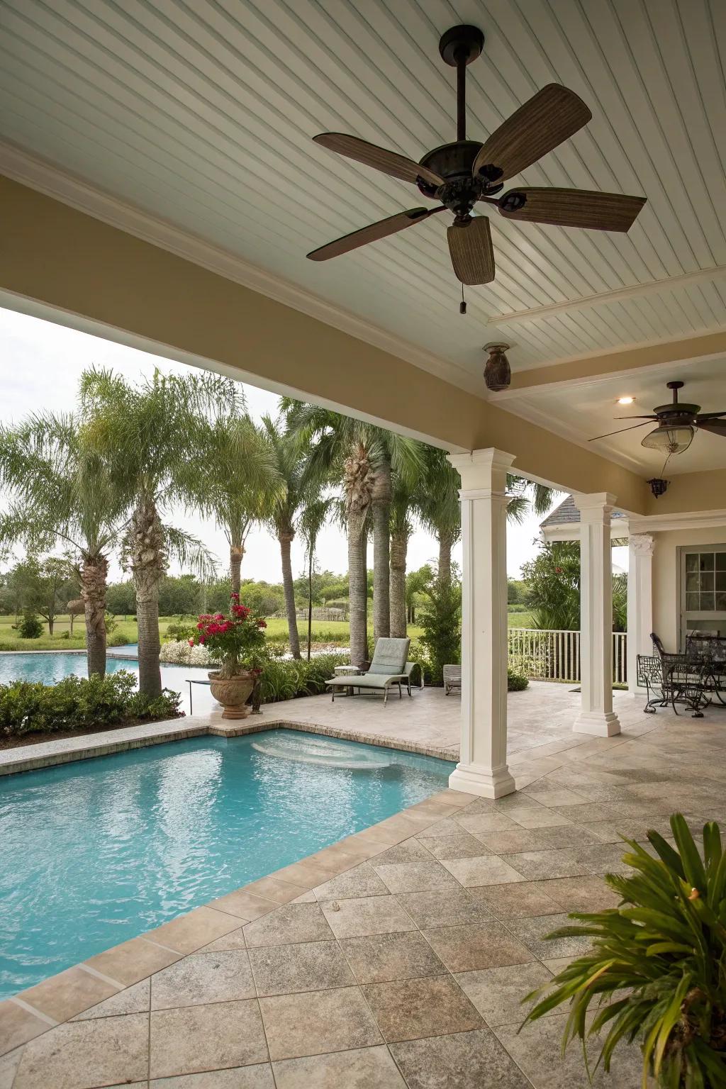 A poolside porch equipped with a practical ceiling fan.