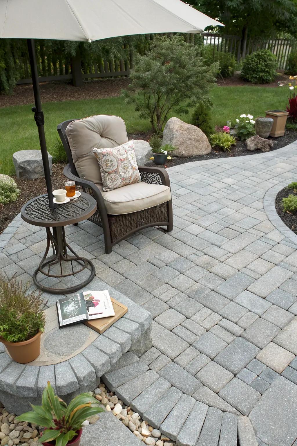 A cozy reading nook offers a private retreat on a gray paver patio.
