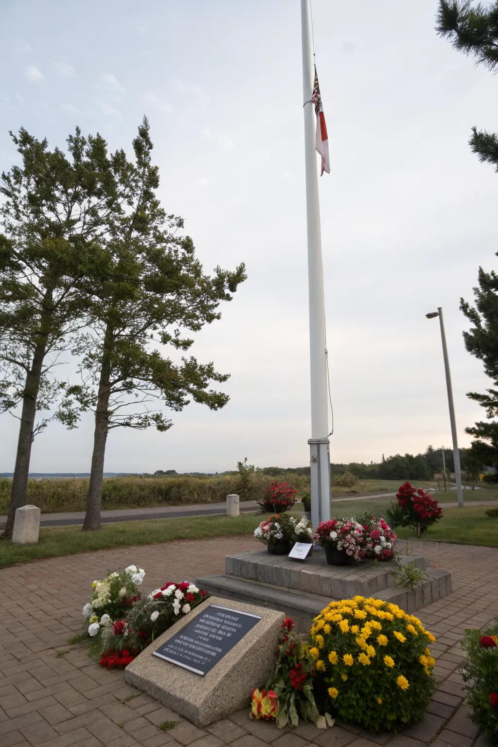 A memorial plaque adds personal significance to the flagpole.