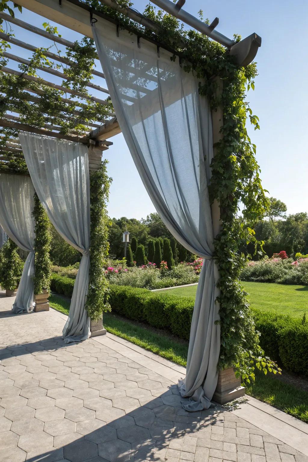 Elegant grey outdoor curtains providing softness and privacy in a garden pergola.