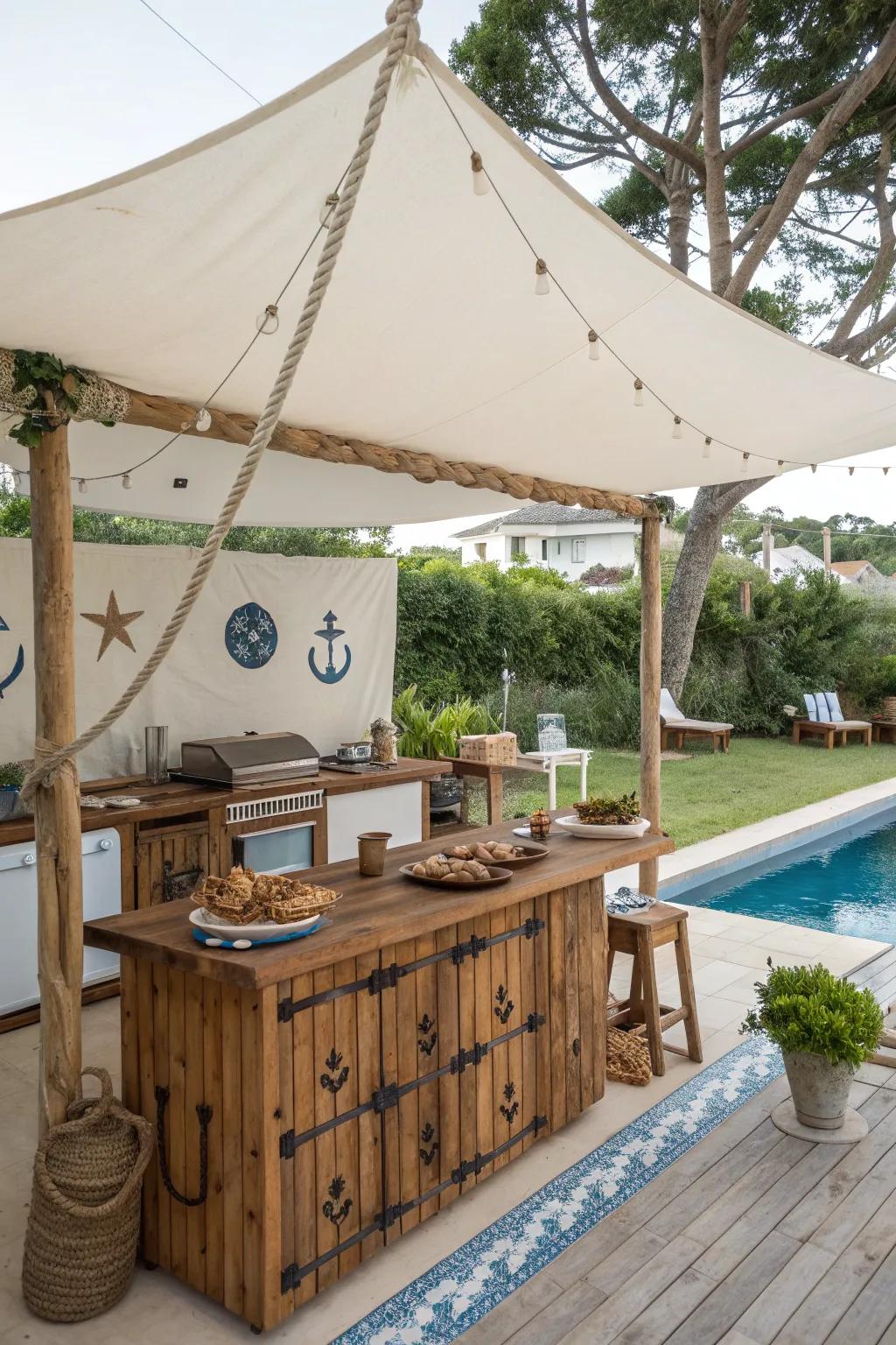 A sailcloth canopy adds a nautical touch to this poolside outdoor kitchen.