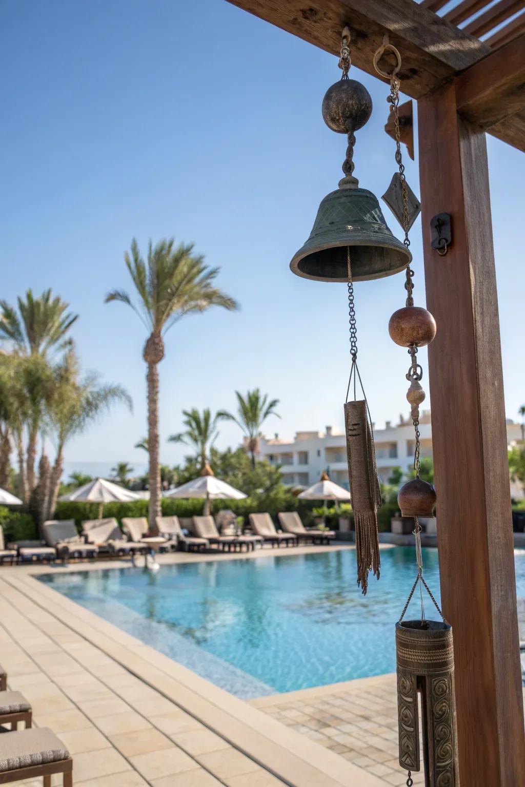Wind chimes add a calming auditory element to the pool area.
