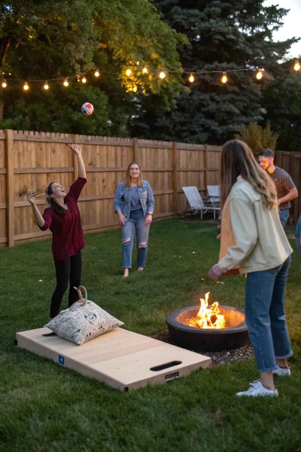 Friends enjoying a game of cornhole by the bonfire.