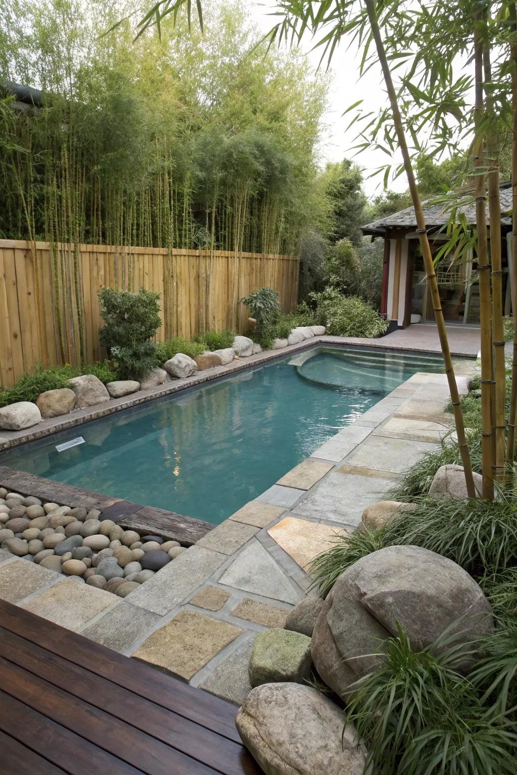 Bamboo and rocks create a serene, Asian-inspired poolside landscape.
