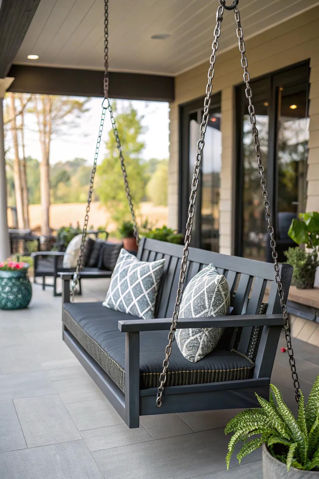 A charcoal porch swing provides a bold and modern touch to the porch.