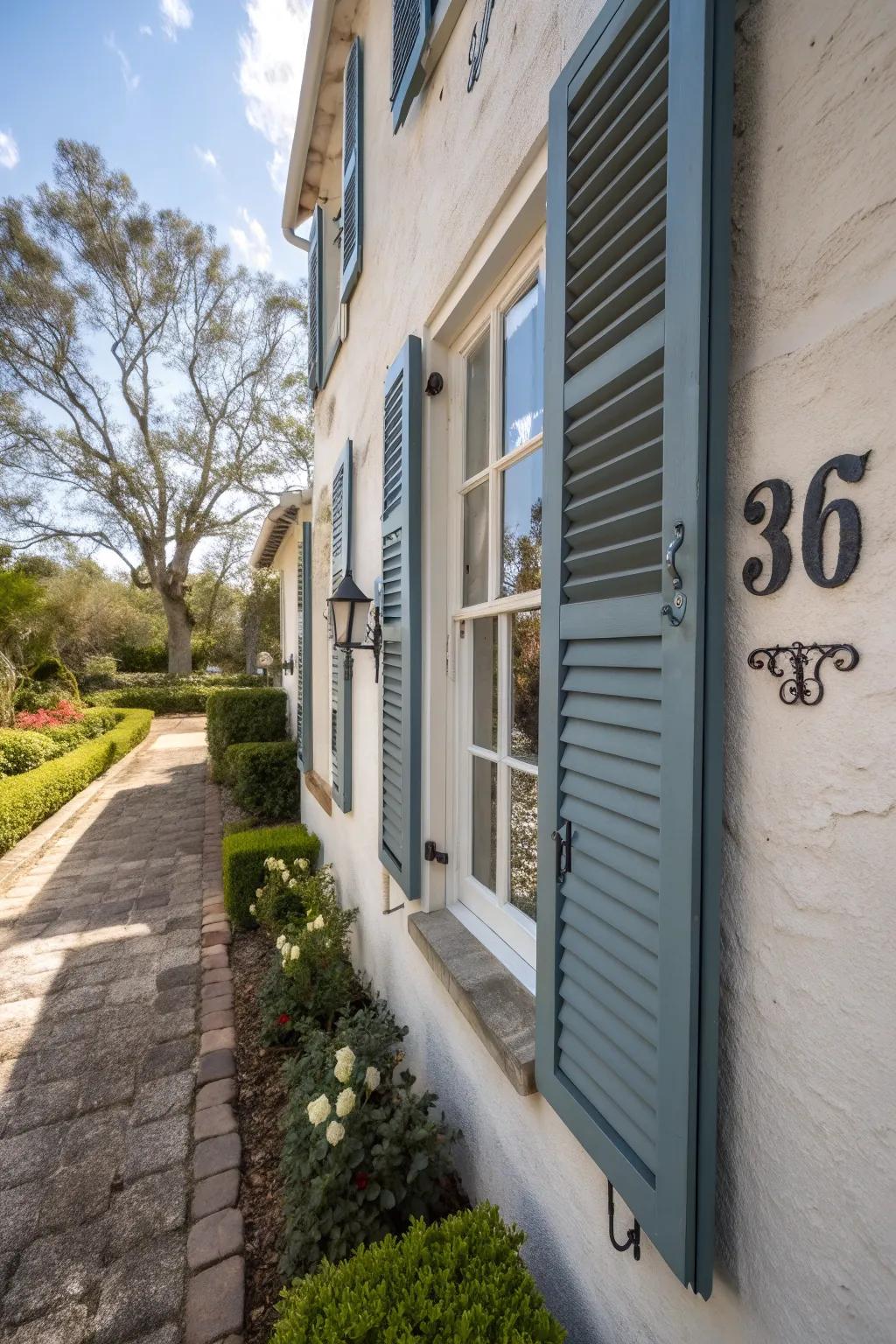 House numbers painted on window shutters.