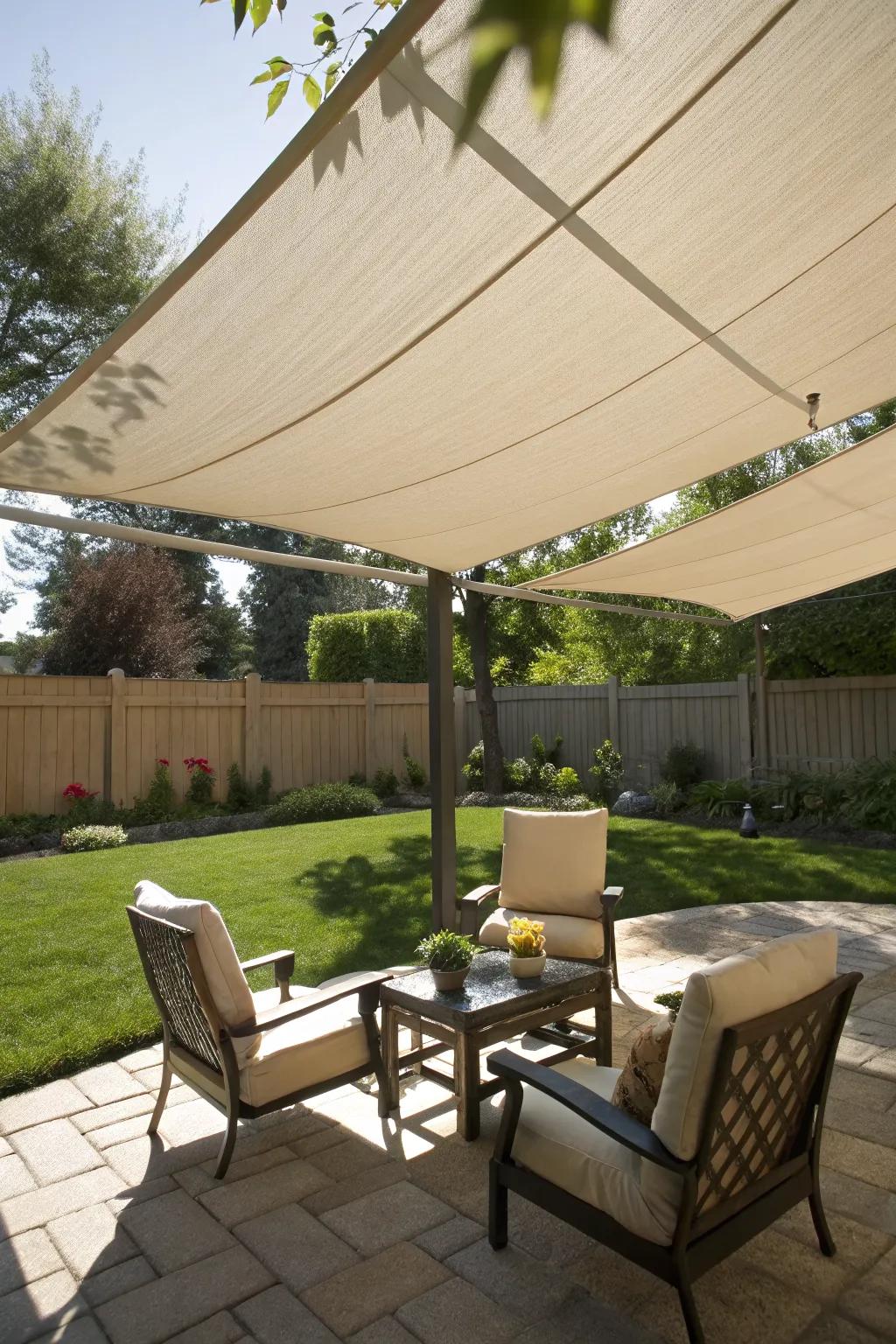 Neutral sail shades providing elegant coverage over a serene patio.