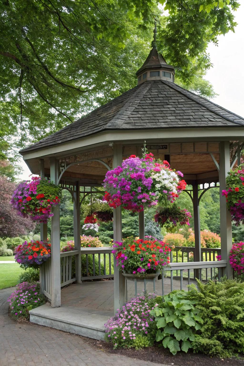 Hanging baskets bursting with colorful petunias and fuchsias bring life to this gazebo.