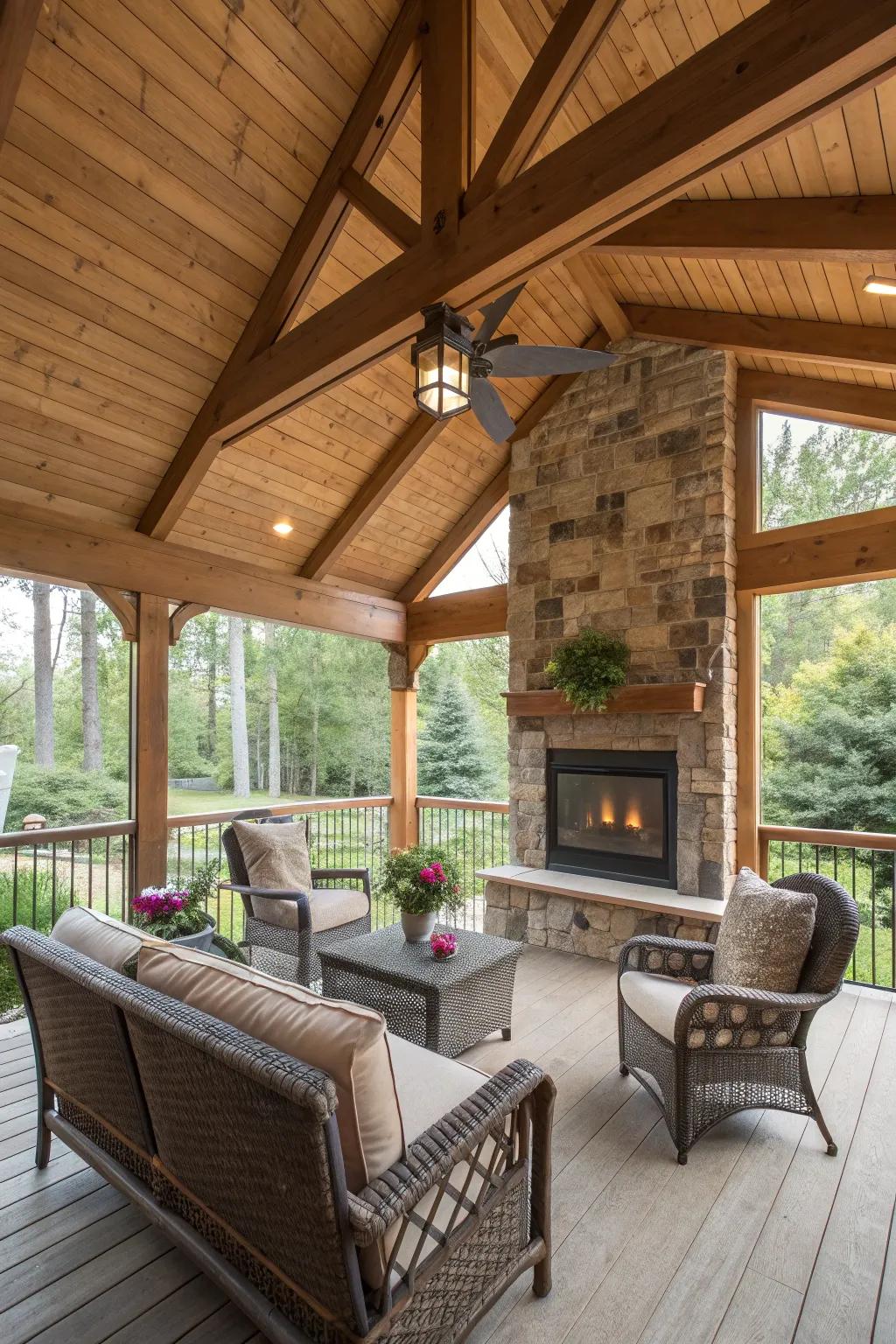 Screened porch featuring wooden ceiling beams and a cozy fireplace.