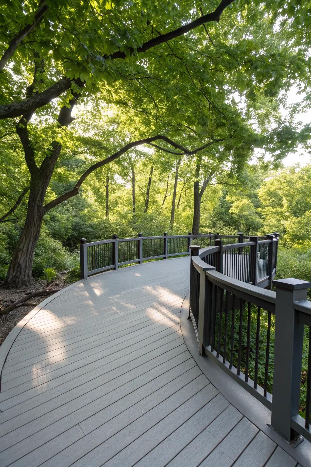 A beautifully curved grey deck with black accents, adding elegance to the garden.