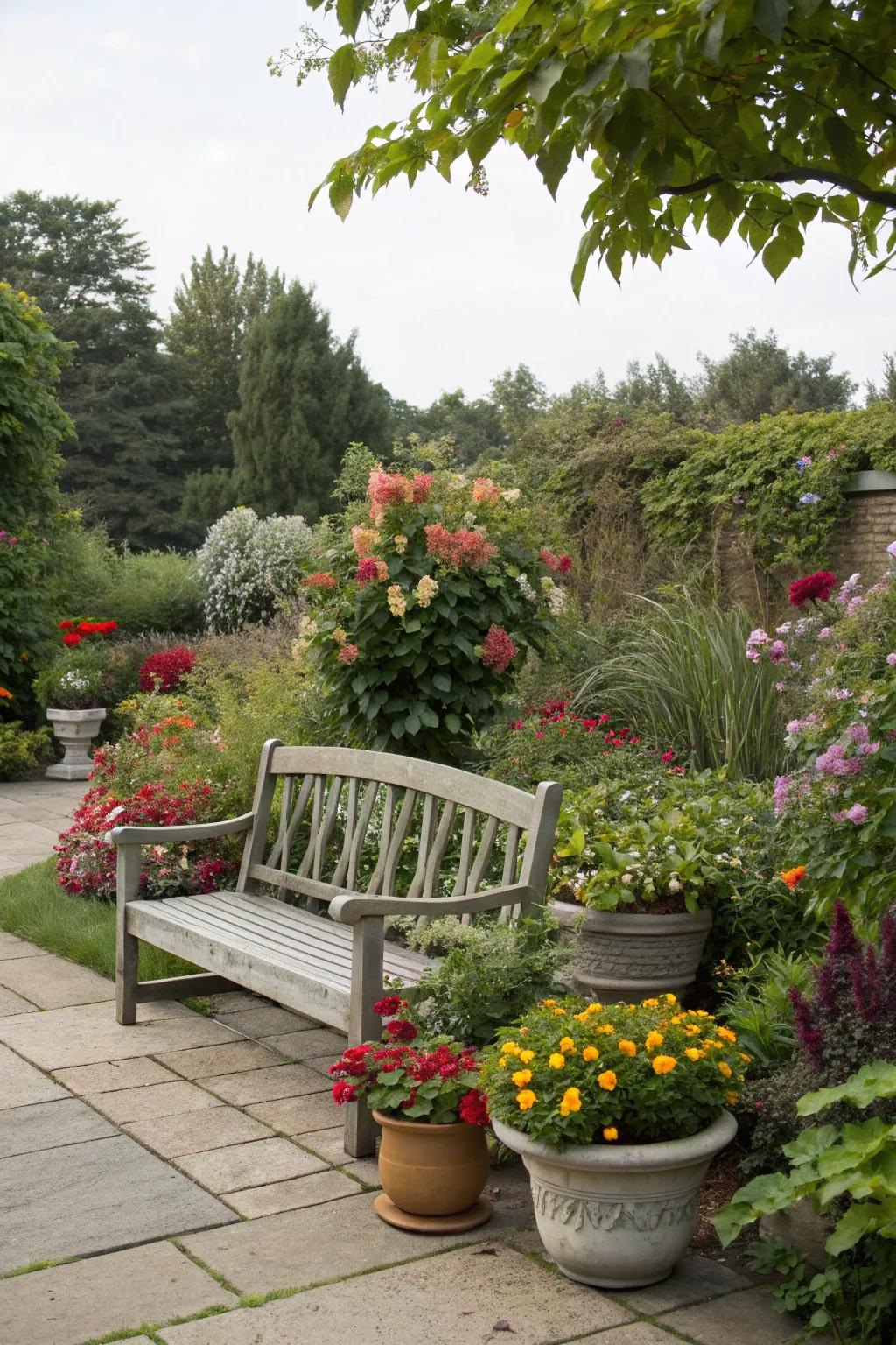 A bench surrounded by vibrant potted flowers and greenery.