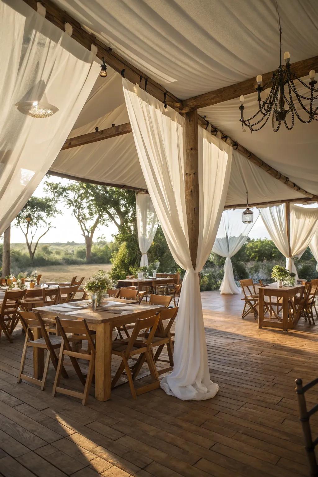 A rustic elegant tent featuring wooden furniture and soft white drapes.