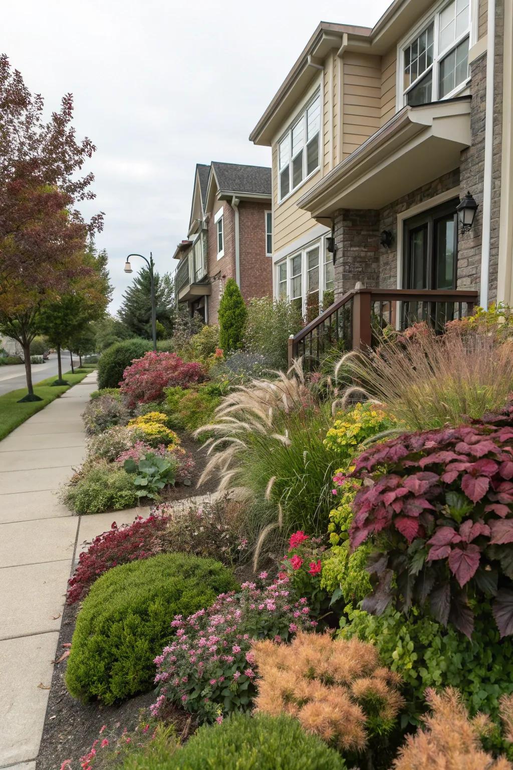 A vibrant mix of plant textures adding depth to a townhouse front yard.