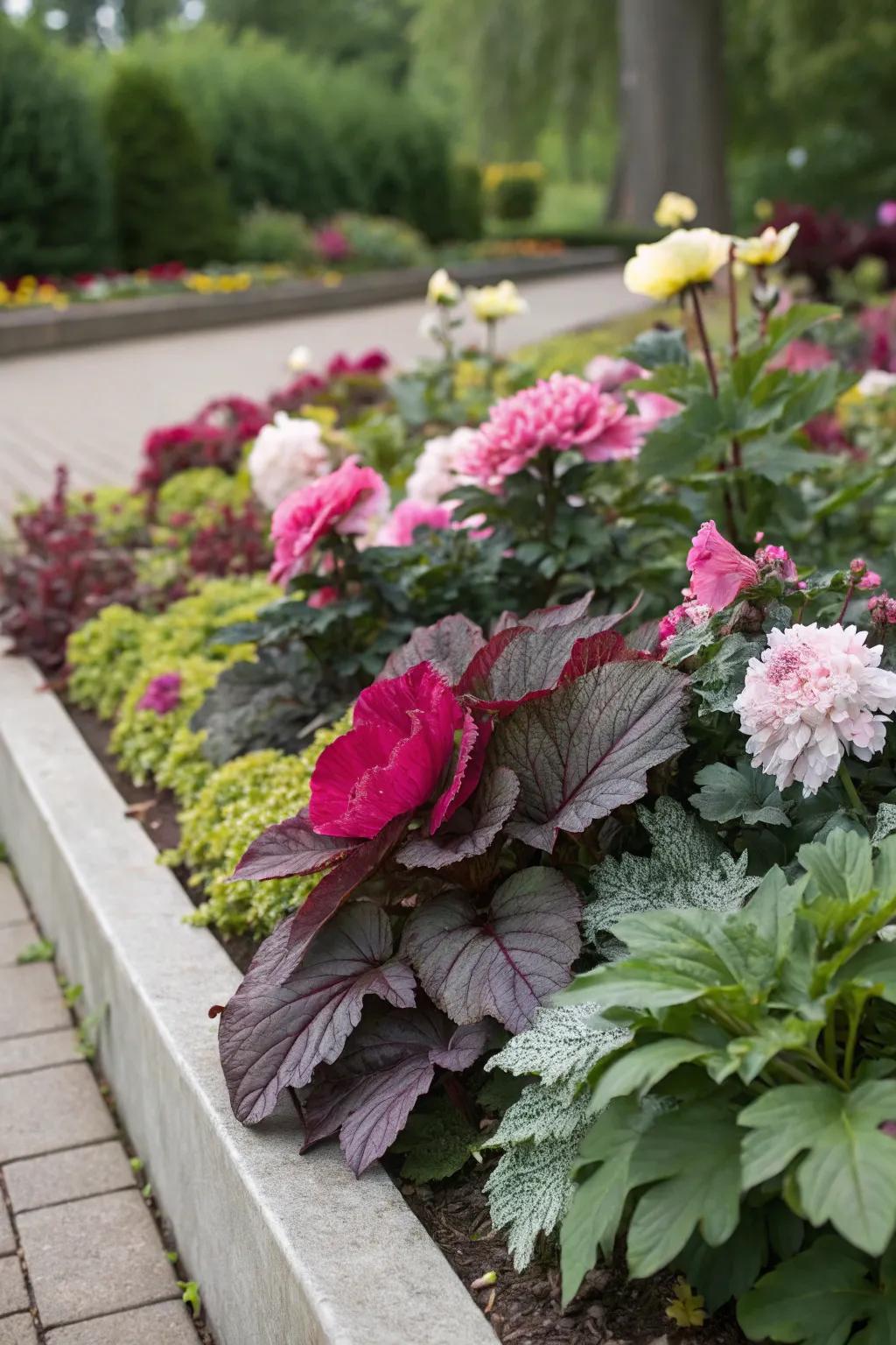 A textured garden bed combining peonies with diverse foliage.