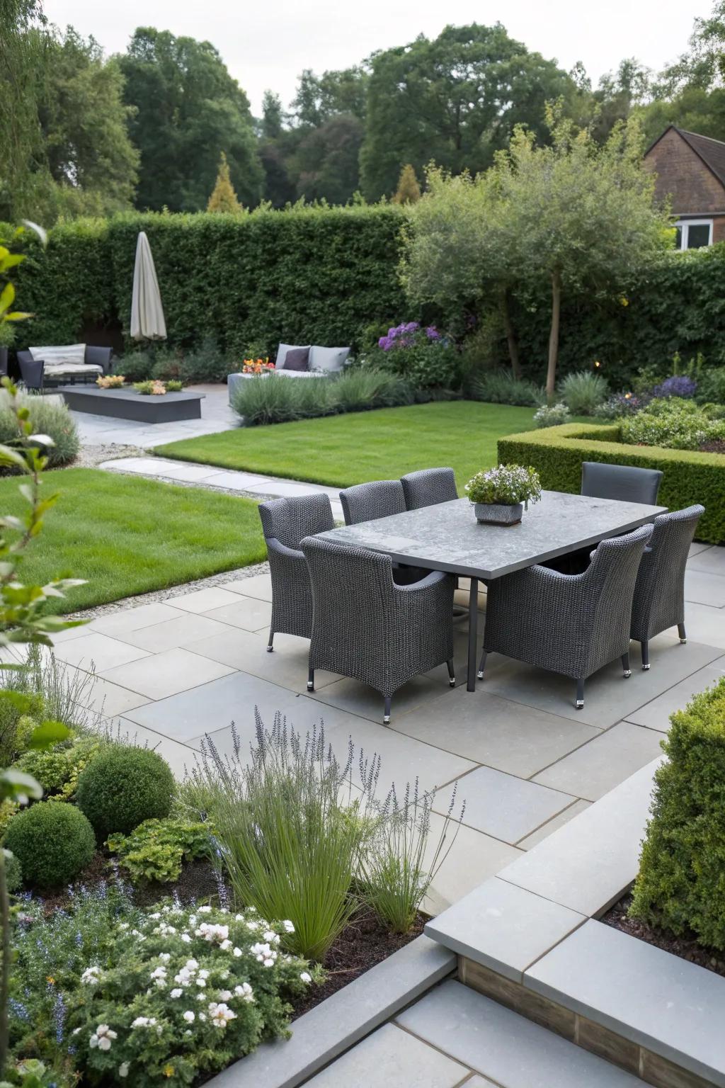 A garden featuring a modern paved area for seating and dining.