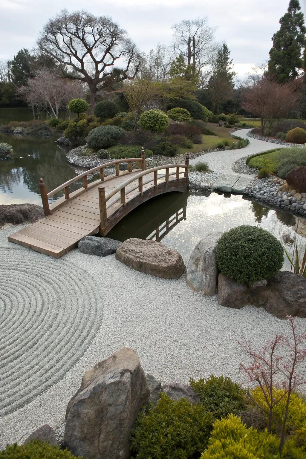 A small wooden bridge in a zen garden symbolizes passage and introspection.