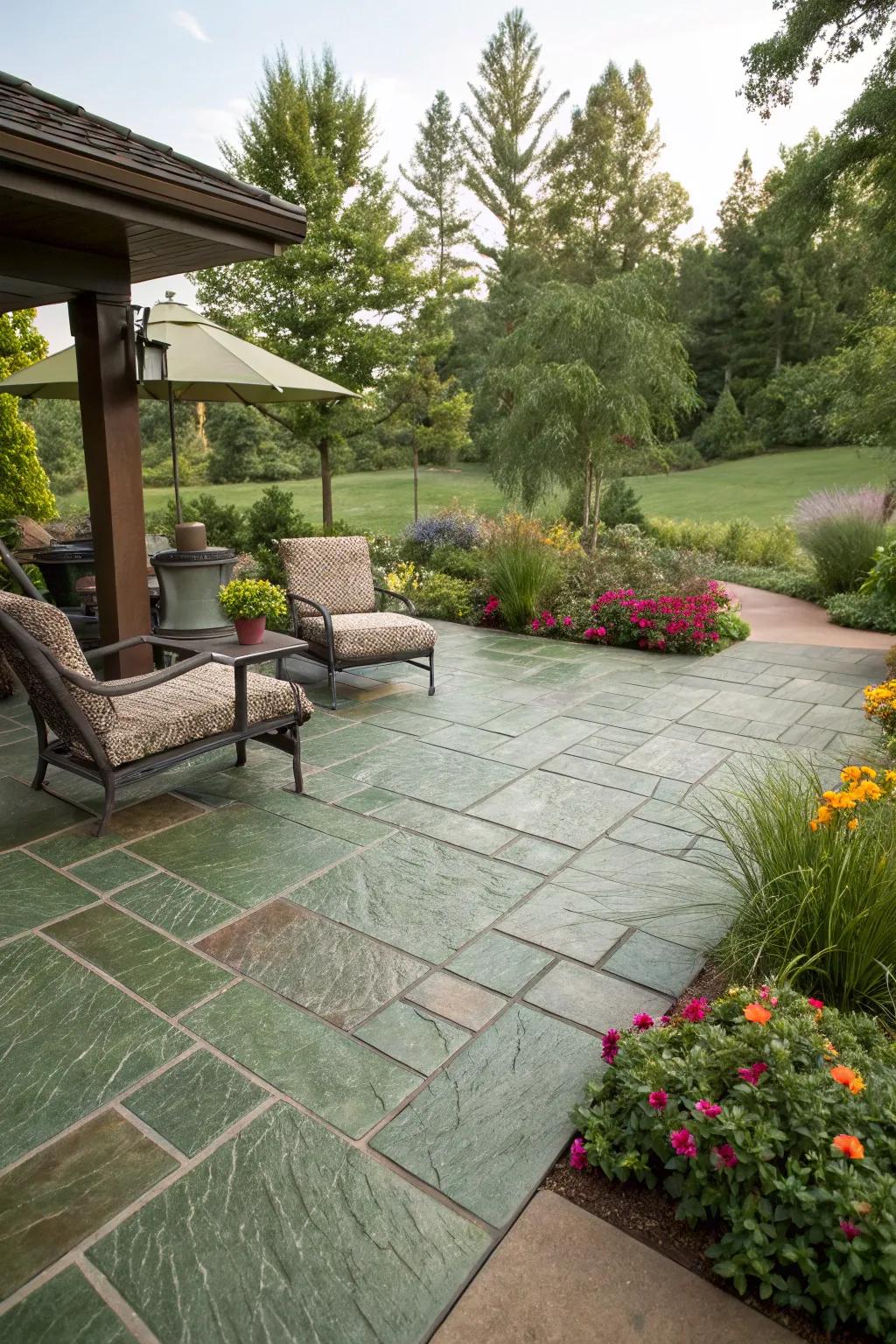 A unique patio featuring earthy green tile pattern stamped concrete, harmonizing with the garden.