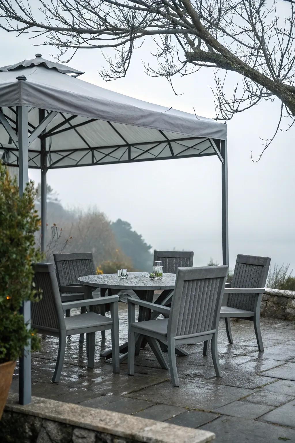 A modern outdoor dining area with a grey table and chairs set against a garden backdrop.