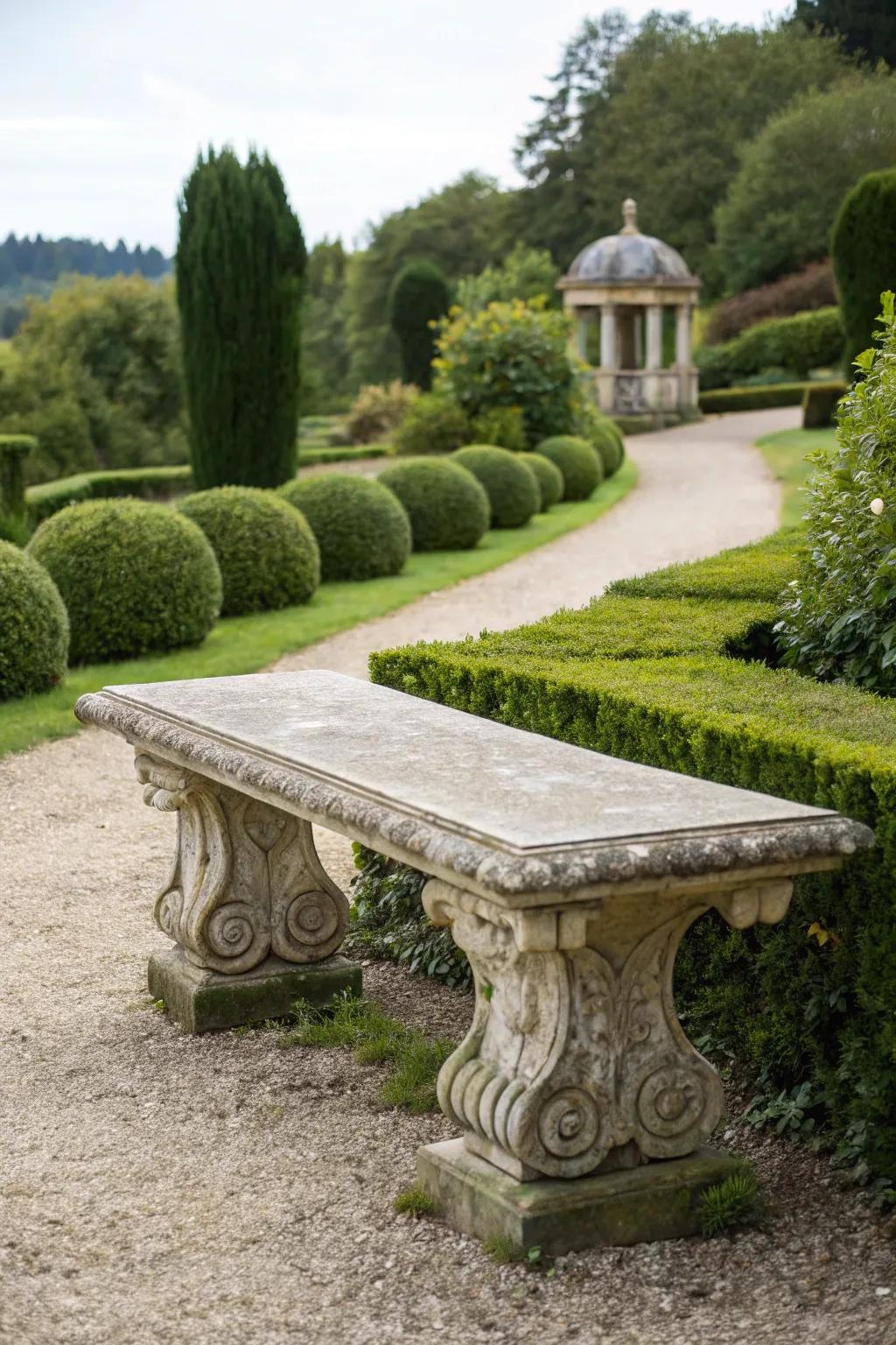 A classical stone bench with ornate pedestal bases.