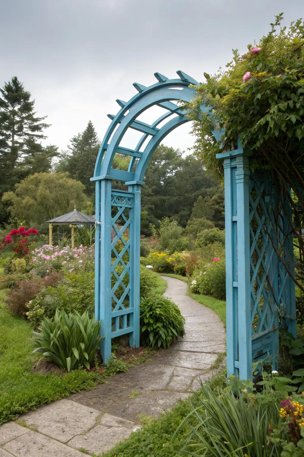 A bold blue garden arch standing out amidst lush greenery.
