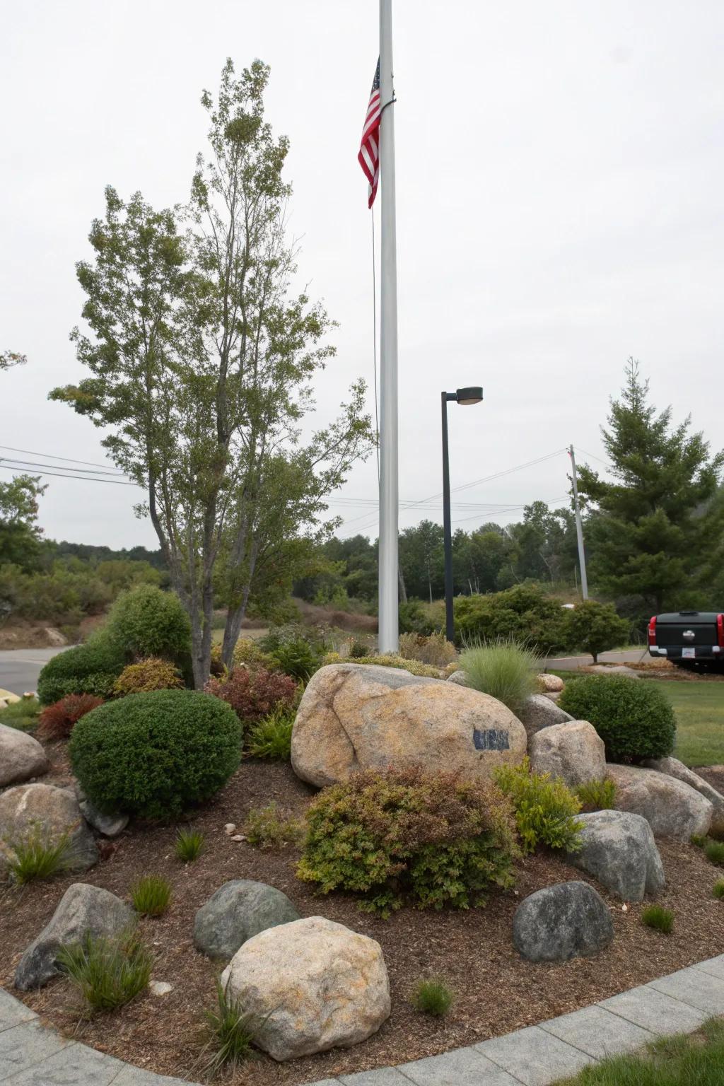 Decorative rocks add a rustic touch to the flagpole base.