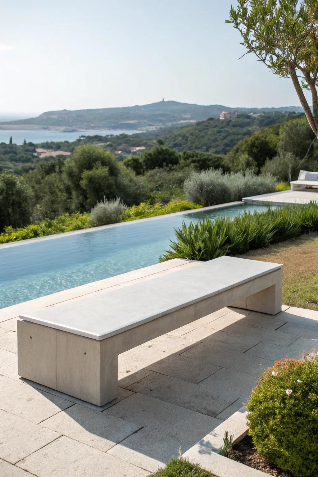A chic concrete bench that complements the poolside ambiance.