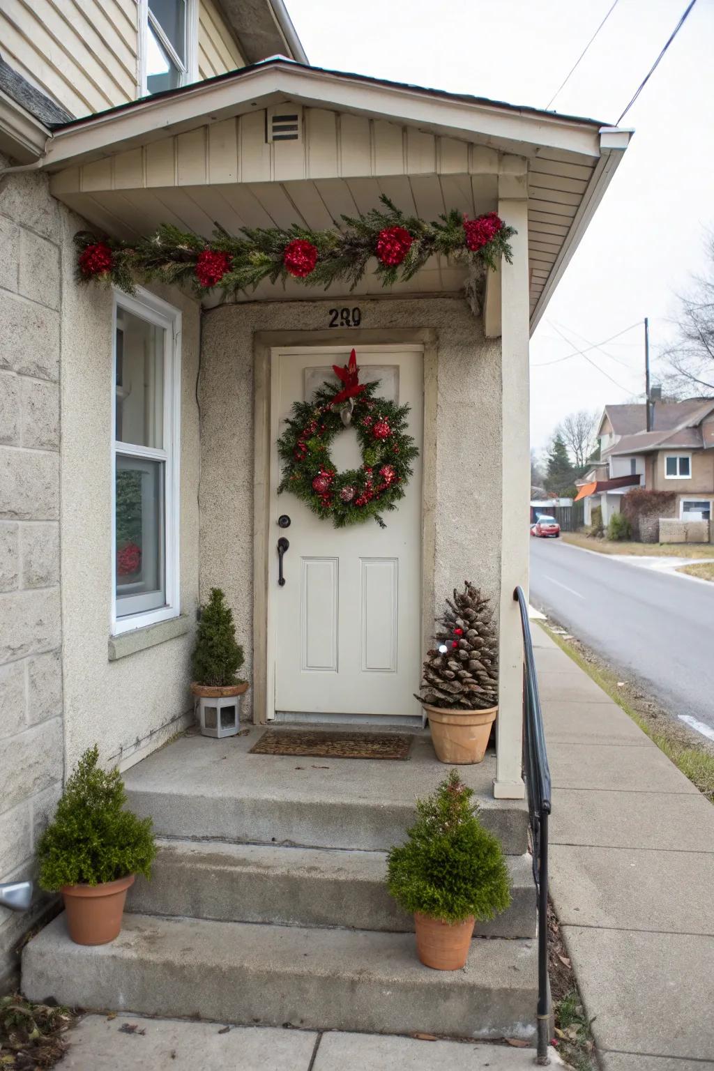 A small concrete porch with a seasonal wreath on the door.